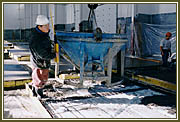 Pouring concrete on one of the IHI Show Home ground floor panels, utilizing the newly-installed overhead cranes.