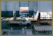 Painters preparing the flashings for the exterior walls of the production area.