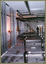 Mechanical air ducting and plumbing system being installed.