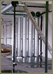 Mechanical air ducting and plumbing system being installed.